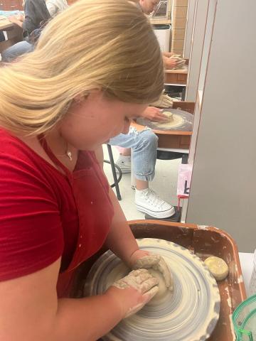 students using pottery wheels in ceramics
