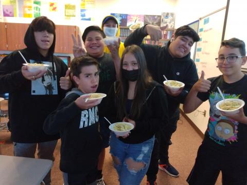ESL students holding their pasta