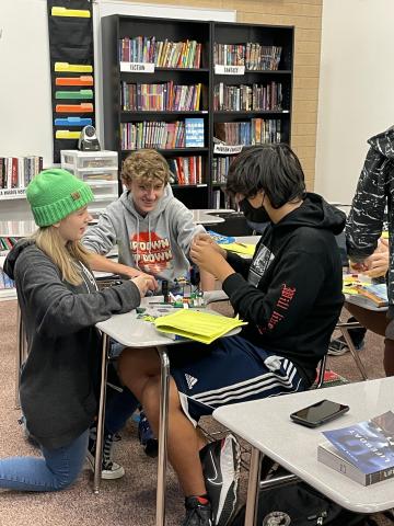 students building lego scenes from lit circle books