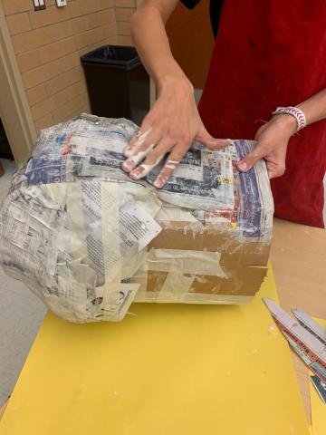 students working on paper mache masks
