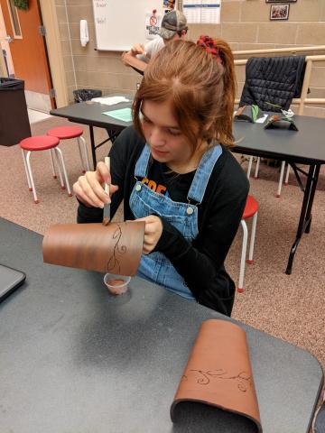 students creating their arm braces 