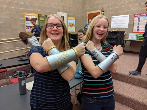 students showing their arm braces 