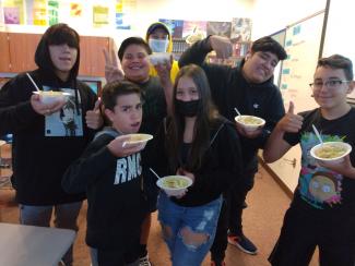 ESL students holding their pasta