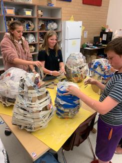 students working on paper mache masks